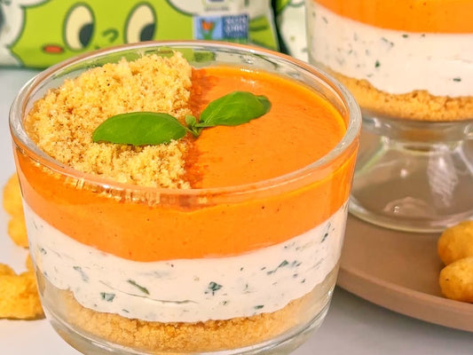 CauliPuffs cheesecake in a glass surrounded by loose puffs