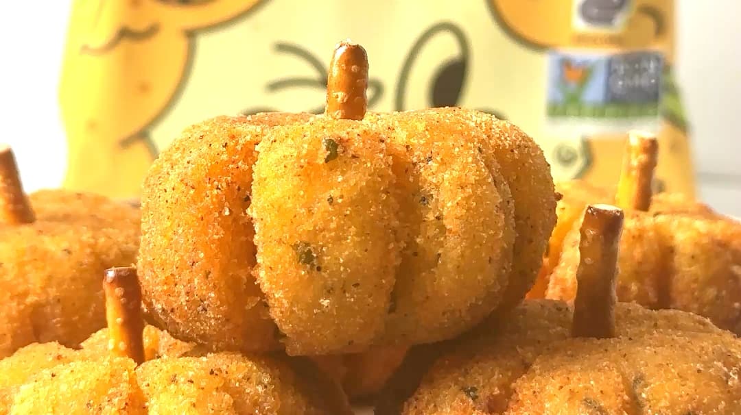 Close up of a pumpkin shaped potato cheese ball